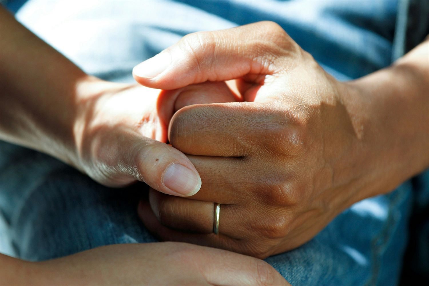 A hand resting gently on another person's arm